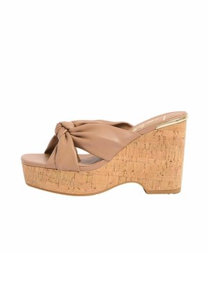 Beige wedge sandal with cork platform heel and wide knotted strap across the front, open toe and slip-on style.