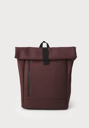 Maroon roll-top backpack with a black strap, featuring a side zipper pocket and a smooth, textured fabric. Simple rectangular design.