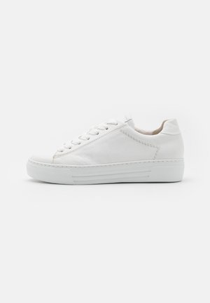 White leather sneaker featuring a textured surface, round toe, lace-up design, and a thick rubber sole with horizontal stripes.