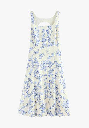 Floral dress in cream with blue flowers. Features a scoop neckline and a back cutout. Made from lightweight fabric with a flowing silhouette.