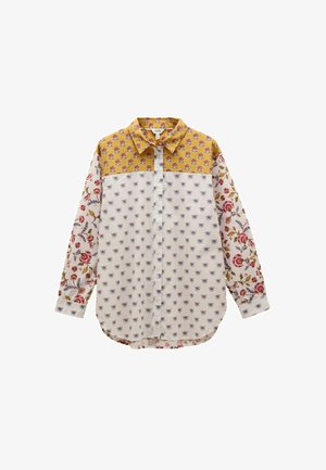 Long-sleeve button-up shirt with yellow floral yoke, white body with small blue flowers, and white sleeves with red and green floral patterns.