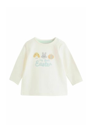 Bílá bavlněná košile s dlouhým rukávem s vyšívanými motivy zvířat (kuřátko, zajíček, včela) a nápisem "můj první Velikonoce" v jemných barvách.