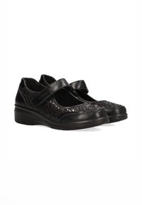 Zapatos Mary Jane negros con parte superior de piel texturizada, una correa de gancho y bucle, y una entresuela acolchada para mayor comodidad.