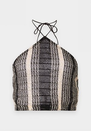 Top corto con paillettes bianco e nero, stile halter con lacci da annodare al collo e motivo a righe verticali.