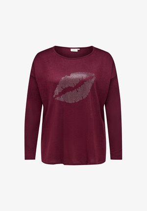 Burgundy pitkähihaista toppia pehmeästä kankaasta, jossa on hopeinen strassihuulipainatus etuosassa, pyöreä pääntie ja rento istuvuus.