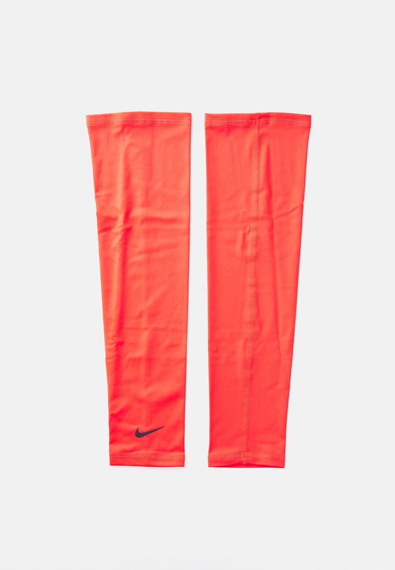 Nike arm sleeves i klar oransje stoff, glatt tekstur, middels lengde, med en svart logo nær bunnen og svingte kanter.