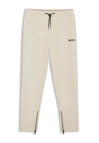 Light beige jogger pants made of soft fabric, featuring an elastic waistband, drawstring closure, side pockets, and zippered cuffs. "BOSS" logo displayed.