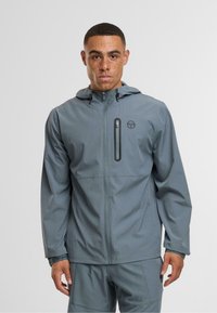 Gray lightweight jacket with a hood, featuring a front zip closure and chest pocket, made from smooth, water-resistant material.