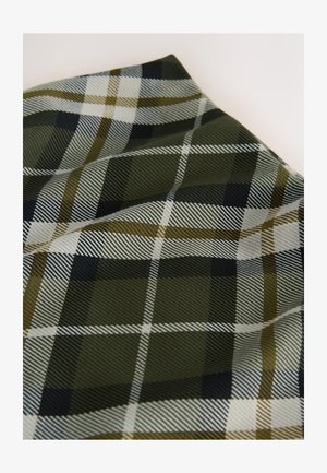 Plaid fabric in dark green and black, featuring white and olive stripes. The texture is smooth with subtle sheen, showcasing a woven pattern.