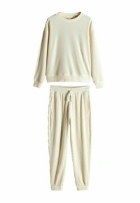 Krämlik ribbad sweatshirt med rund halsringning och långa ärmar, i kombination med matchande ribbade tapered sweatpants med justerbar dragsko.