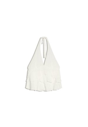 Bela brezrokavnik z globokim V-izrezom in plastnim volanom na robu, zavezana na vratu.