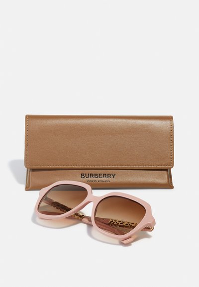 Burberry branded sunglasses with a pink oversized frame and gradient brown lenses, accompanied by a smooth, metallic bronze case.