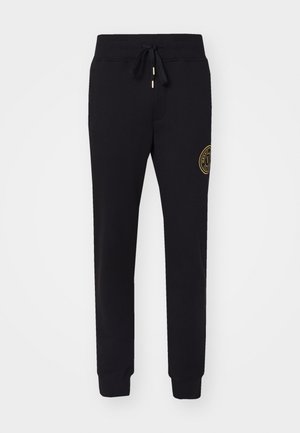 Pantaloni sportivi neri in misto cotone con vita regolabile con coulisse, gamba affusolata, tasche laterali e dettaglio del logo ricamato in oro sulla coscia.