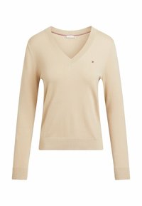 Beżowy sweter z dekoltem w serek i długimi rękawami, wykonany z miękkiego dzianiny. Posiada małe logo na lewej piersi oraz prążkowane wykończenia na mankietach.