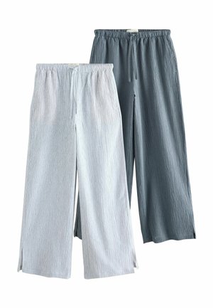 Two pairs of wide-leg pants with drawstring waistbands, one light gray and one dark gray, featuring a textured fabric and small side slits.