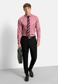 Formal outfit featuring a pink checkered shirt, striped tie in red and white, black trousers, and black shoes. Holding a black briefcase.