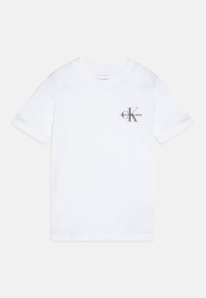 T-shirt bianco in cotone con colletto tondo, maniche corte e logo grigio Calvin Klein Jeans sul petto. Texture liscia, vestibilità classica.