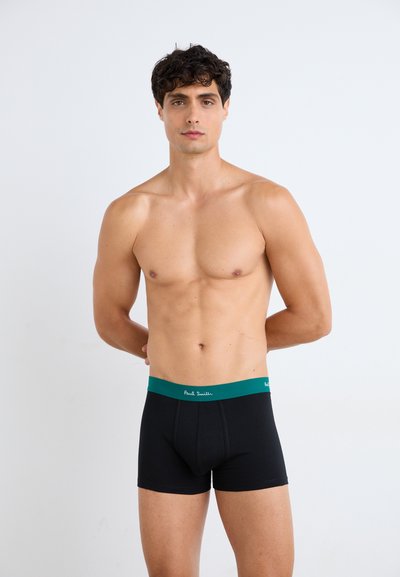 Čierne boxerky s elastickým pásom v zelenej farbe s logom "Paul Smith". Tkanina sa javí ako hladká a dobre prilieha na telo.