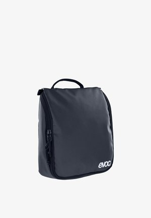 Donkerblauwe reistas met een textuurlijke, zachte buitenkant, ritsluiting en een handvat bovenop; voorzien van branding aan de voorkant.