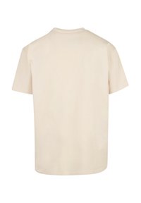 Beige Baumwoll-T-Shirt, kurze Ärmel, Rundhalsausschnitt, einfarbig, leichtes Material, gerader Saum, keine sichtbaren Muster oder Akzente.