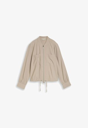 Beige leichte Jacke mit Frontreißverschluss, zwei Brusttaschen, Kordelzug am Saum, langen gesammelten Ärmeln und breiten Manschetten.