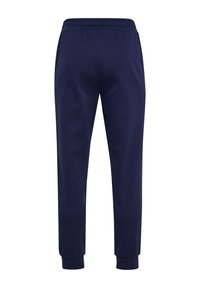 Mørkeblå sweatpants lavet af blødt stof med elastisk talje og manchetter, der har en lige ben design og ingen synlige logoer eller mønstre.