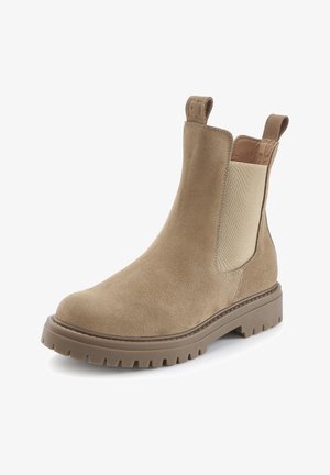 Beige suede Chelsea boot with chunky rubber sole, elastic side panels, and pull tabs on front and back of ankle.