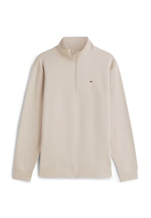 Beige long-sleeve pullover with quarter zip and small colored logo on the left chest, ribbed cuffs, and hem.