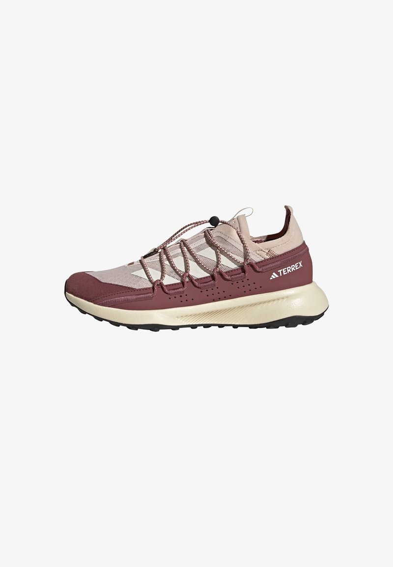 Maroon and beige athletic shoe featuring a mesh upper, elastic laces, and a textured sole, with a low profile and cushioned midsole.
