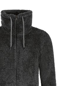Veste noire duveteuse zippée avec col montant et cordons blancs sur fond blanc.