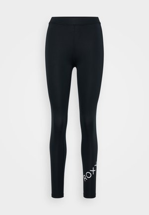 Sorte leggings laget av glatt, elastisk stoff. Har en bred midjebånd og en hvit logo på den nedre siden. Formtilpasset design.