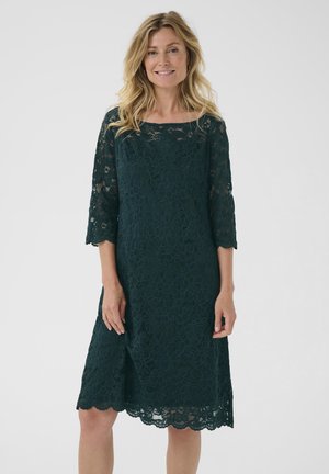 Green lace dress with three-quarter sleeves, floral pattern, scalloped hem, and loose fit, designed for ease of movement.