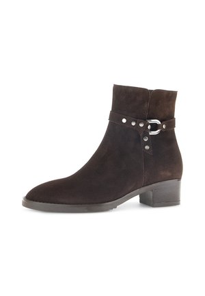 Brown suede ankle boot with a rounded toe, a low block heel, and a decorative strap featuring silver hardware and circular accents.