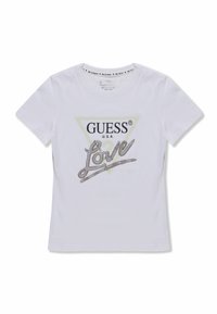 Witte katoenen t-shirt met een driehoekige grafiek waarin de tekst "GUESS" staat, verfraaid met een strassaccent op "Love" in zilver en lichtgroen.