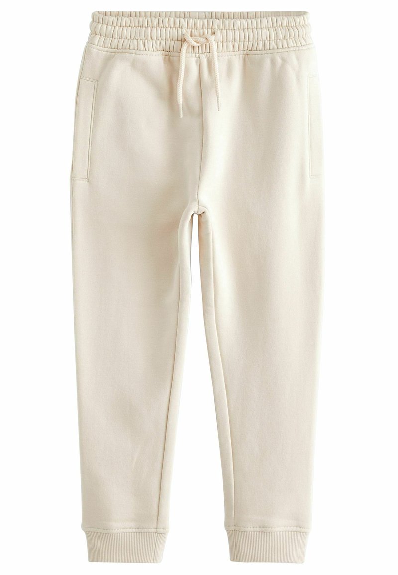 Pantalon de jogging écru avec ceinture élastique, cordon, poches latérales et poignets côtelés.