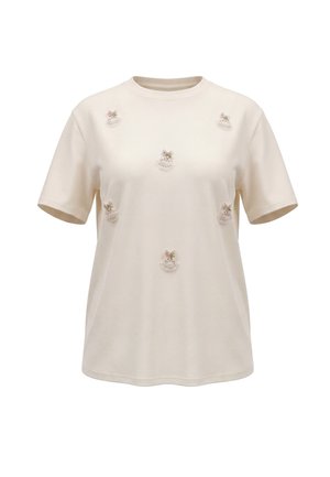 Jasnokremowy T-shirt z krótkim rękawem i okrągłym dekoltem, ozdobiony sześcioma małymi haftowanymi aplikacjami z koronkowych kwiatów rozmieszczonymi z przodu.