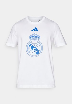 Witte katoenen t-shirt met een blauw Real Madrid logo en kroon ontwerp. Inclusief blauwe Adidas branding op de bovenborst. Korte mouwen.