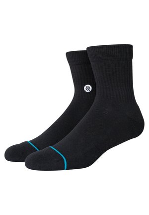 Black cotton socks with a ribbed texture, featuring a white logo on the side and a blue accent at the toe. Mid-calf length design.