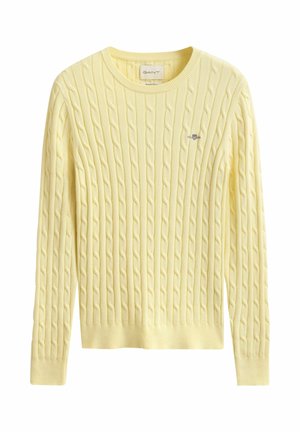 Light yellow cable-knit sweater with long sleeves, round neck, and small embroidered logo on the chest.