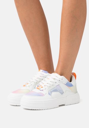 White sneakers with a chunky sole, featuring pastel accents in lavender, orange, and blue, along with lace-up closure and branding detail.