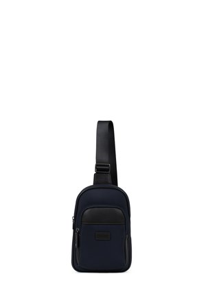 Petit sac bandoulière bleu marine et noir avec poche zippée avant et bandoulière réglable simple.