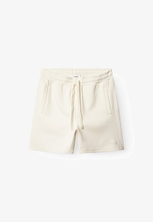 Licht crèmekleurige shorts van gestructureerde stof. Voorzien van een elastische tailleband met trekkoord en twee voorzakken. Logo aan de zijkant.