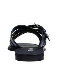Zwarte platte sandalen met meerdere kruisspanden en een zijgesp voor sluiting. De zool is vlak en glad, met een eenvoudig en ingetogen ontwerp.