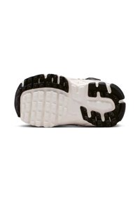 Semelle de sneaker noir et blanc avec une semelle en caoutchouc texturée, présentant un motif de crampons pour une traction et une durabilité améliorées.