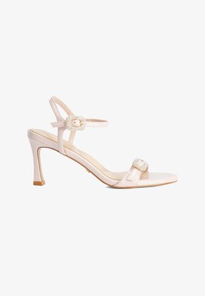 Light pink high-heeled sandal with two pearl-embellished buckles, open toe, and ankle strap on a white background.