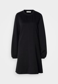 Robe noire à manches longues en ligne A, col rond et poignets élastiques, suspendue à plat sur un fond blanc.