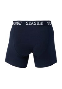 Boxers bleu marine avec une ceinture élastique noire portant le texte blanc répété "SEASIDE".