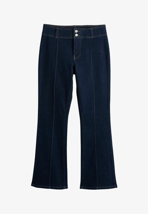 Tumši zilas džinsu bikses ar platiem galiem, priekšējām šuvēm, dubultu pogu aizdari un dzeltenas krāsas kontrastējošām šuvēm.