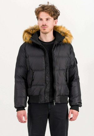 Black puffer jacket with a faux fur-lined hood, ribbed cuffs and hem, and zippered front. Quilted texture with side pockets.