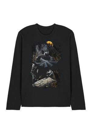Black long-sleeve shirt with a graphic of Batman crouching on a stone ledge in a dark cityscape with a yellow Bat-Signal in the sky.